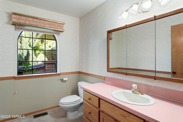 bathroom featuring visible vents, toilet, and vanity