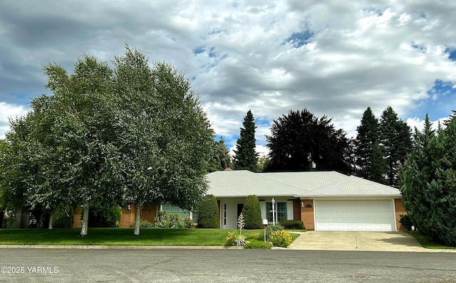 ranch-style house with a front lawn, driveway, and an attached garage