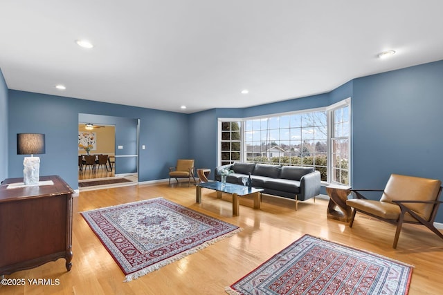 living area featuring recessed lighting, baseboards, and wood finished floors