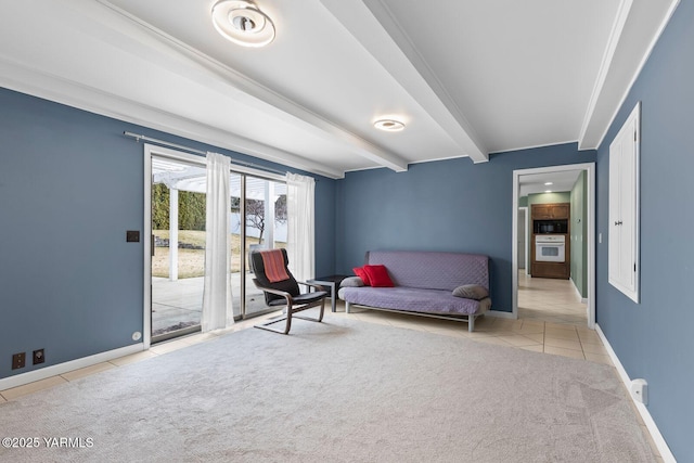 sitting room featuring light tile patterned floors, light carpet, baseboards, and beamed ceiling