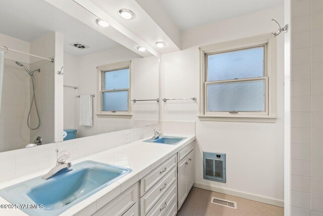 full bathroom featuring a shower, visible vents, and a sink