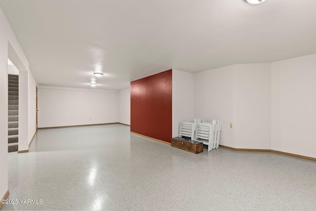 interior space with baseboards and stairs