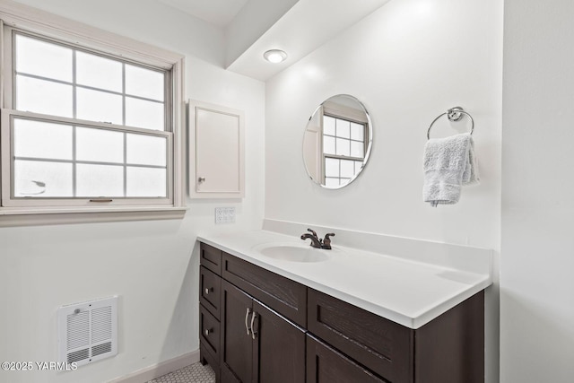bathroom featuring vanity, baseboards, and visible vents