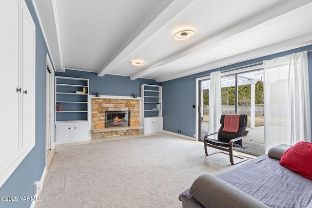 carpeted bedroom with a fireplace, beam ceiling, baseboards, and access to exterior
