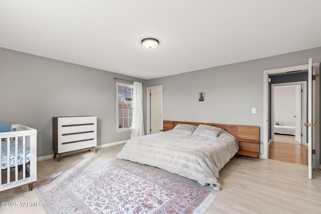bedroom featuring baseboards and light wood-type flooring