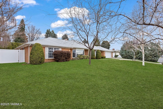 ranch-style home featuring brick siding, fence, an attached garage, concrete driveway, and a front yard