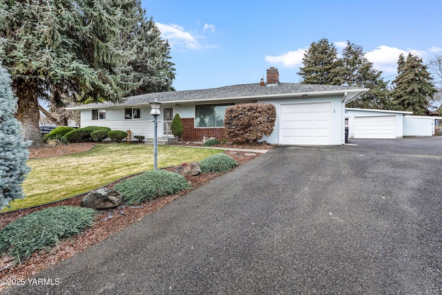 6520 Barge St, Yakima, WA 98908 - single story home with a front yard, a chimney, brick siding, aphalt driveway, and a garage