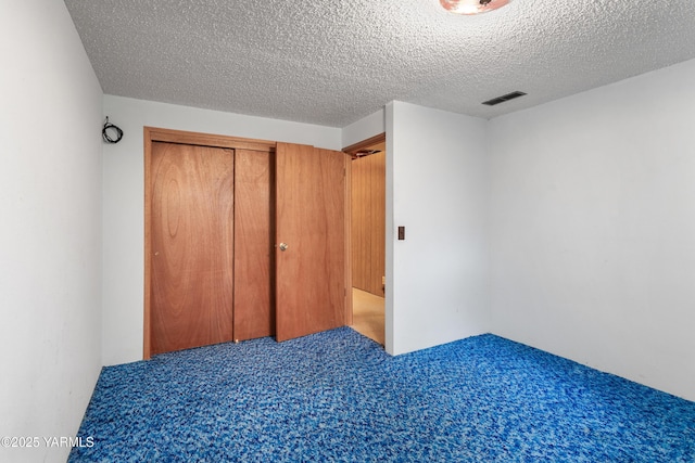6520 Barge St, Yakima, WA 98908 - unfurnished bedroom with a closet, carpet floors, a textured ceiling, and visible vents
