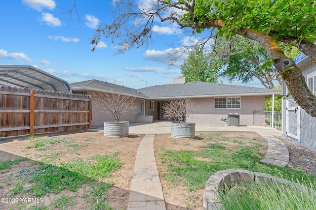 419 S 58th Ave, Yakima, WA 98908 - back of property with brick siding, a patio, a fenced backyard, cooling unit, and a chimney