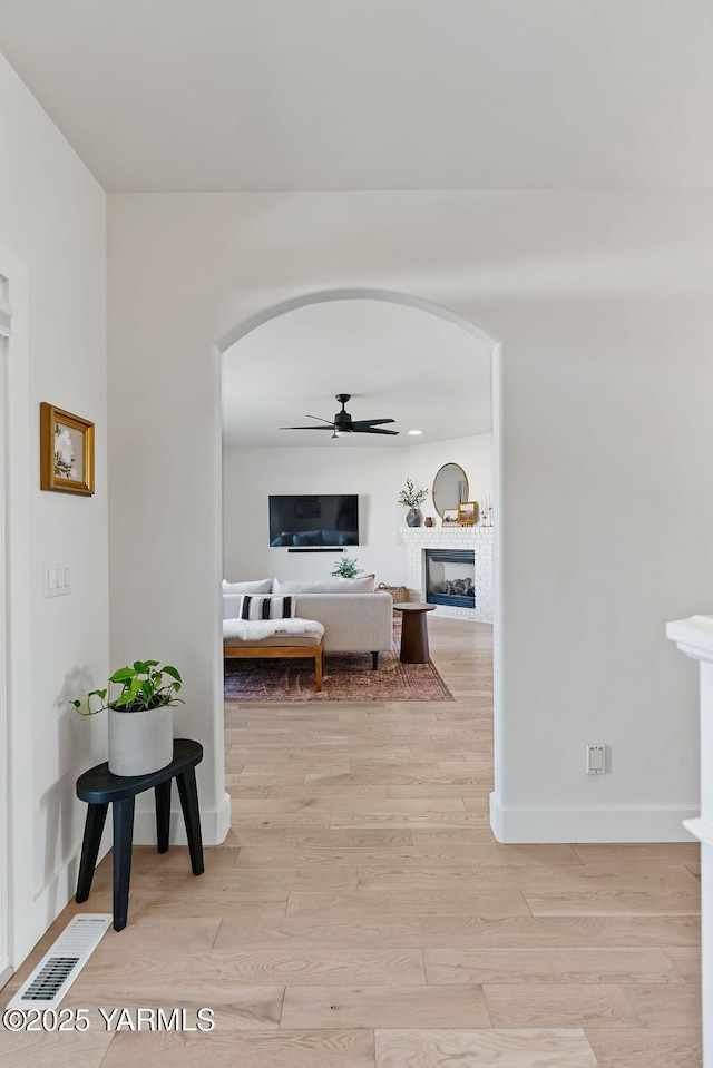 703 S 87th Ave, Yakima, WA 98908 - hall with arched walkways, light wood-type flooring, and baseboards
