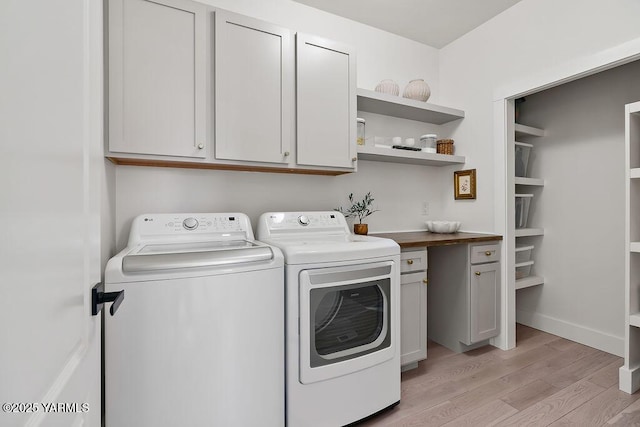 703 S 87th Ave, Yakima, WA 98908 - laundry area with washer and clothes dryer, light wood-style flooring, and cabinet space