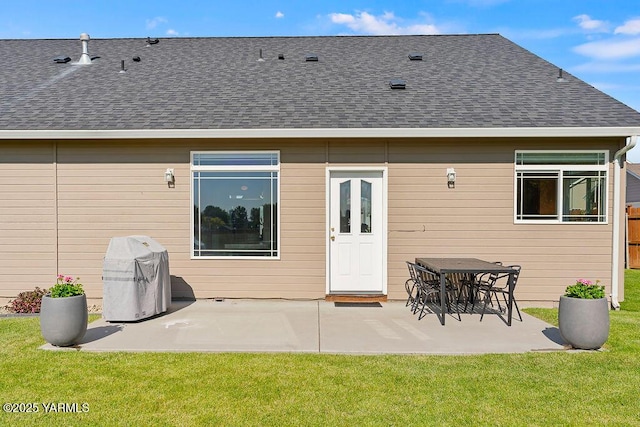 703 S 87th Ave, Yakima, WA 98908 - rear view of house with a shingled roof, a patio area, and a lawn
