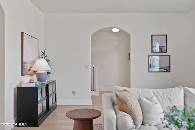 703 S 87th Ave, Yakima, WA 98908 - living room with arched walkways, light wood finished floors, and baseboards