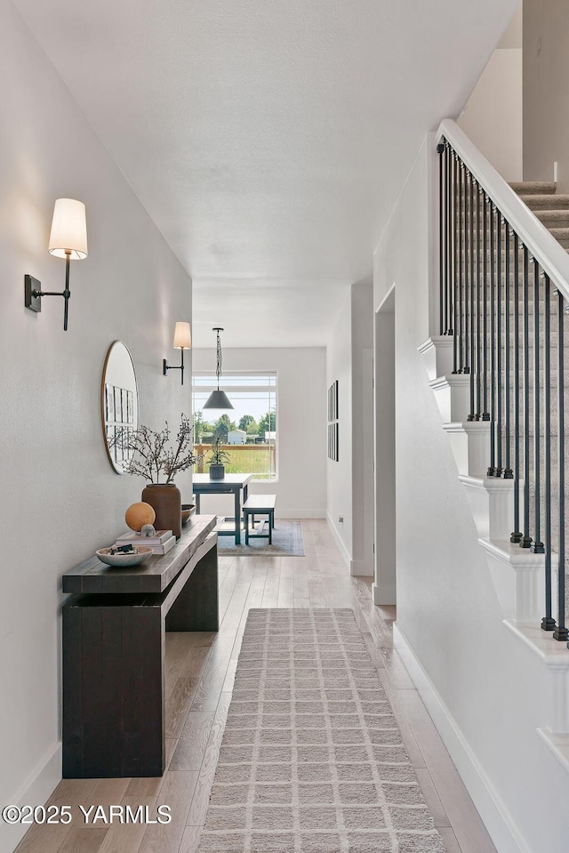 703 S 87th Ave, Yakima, WA 98908 - hallway with stairs, light wood-style flooring, and baseboards