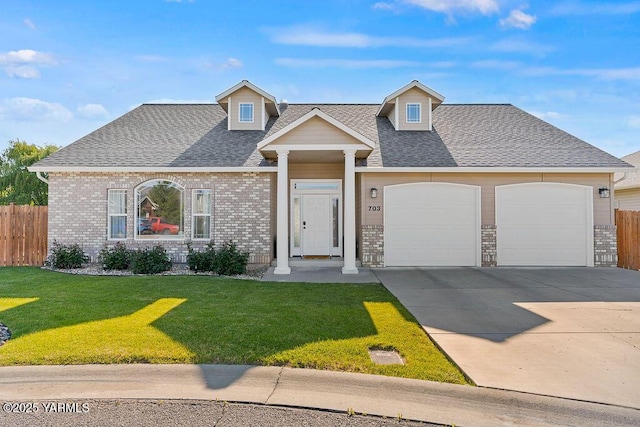 703 S 87th Ave, Yakima, WA 98908 - view of front facade featuring a garage, driveway, and roof with shingles