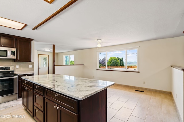 451 Pleasant Valley Pl, Yakima, WA 98908 - kitchen featuring a ceiling fan, backsplash, visible vents, a center island, and stainless steel appliances