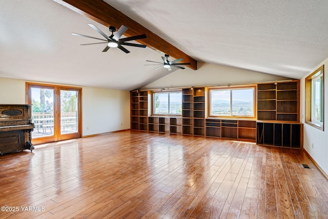 451 Pleasant Valley Pl, Yakima, WA 98908 - unfurnished living room with ceiling fan, lofted ceiling with beams, baseboards, wood finished floors, and visible vents