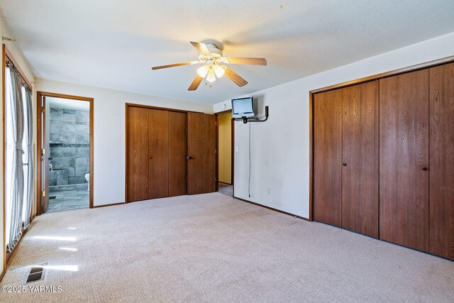 451 Pleasant Valley Pl, Yakima, WA 98908 - unfurnished bedroom featuring two closets, visible vents, light carpet, and ensuite bathroom