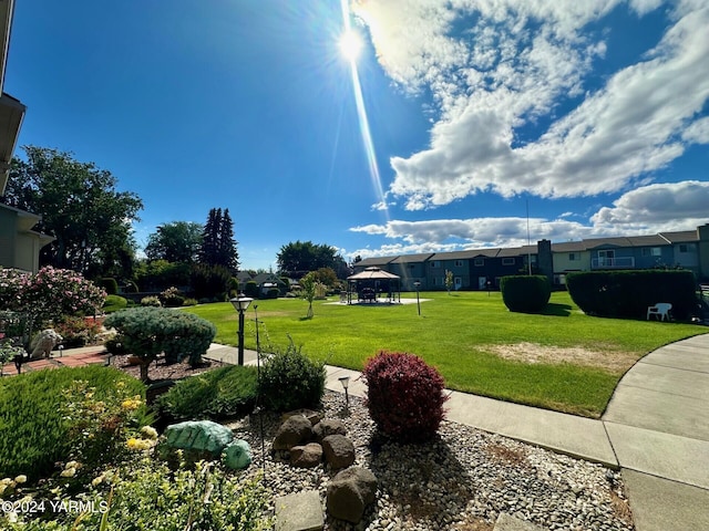 view of property's community featuring a lawn and a gazebo