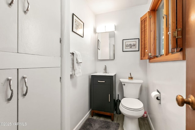 5306 Douglas Dr, Yakima, WA 98908 - bathroom featuring wood finished floors, toilet, vanity, and baseboards