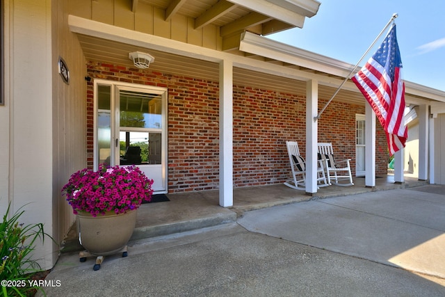 5306 Douglas Dr, Yakima, WA 98908 - property entrance featuring covered porch, brick siding, and board and batten siding