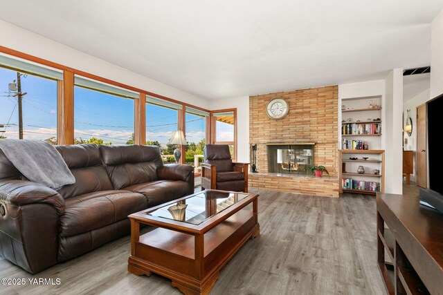 5306 Douglas Dr, Yakima, WA 98908 - living area with wood finished floors, a brick fireplace, and built in features