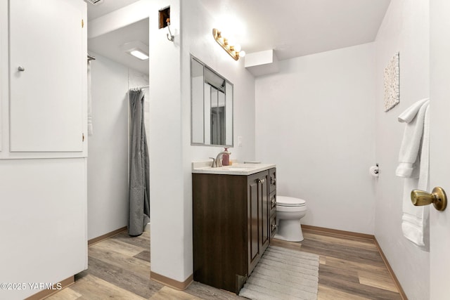 5306 Douglas Dr, Yakima, WA 98908 - bathroom with vanity, wood finished floors, toilet, and baseboards