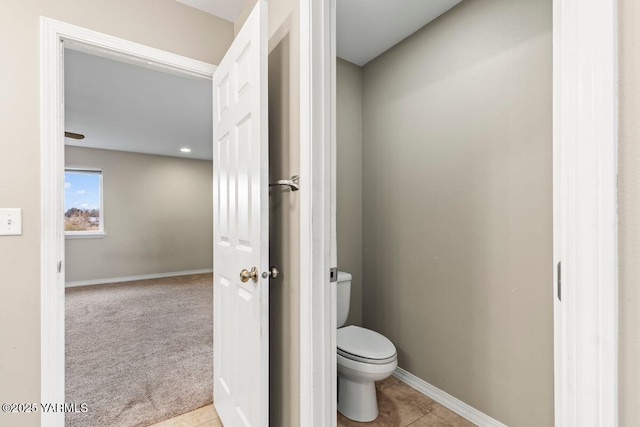 bathroom with tile patterned floors, toilet, and baseboards