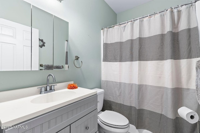 full bath featuring curtained shower, vanity, and toilet