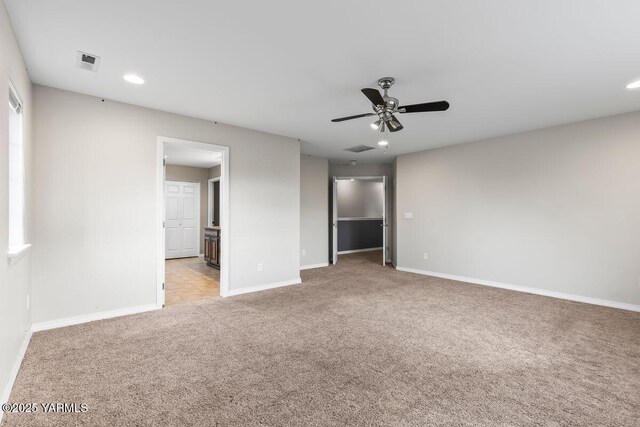 unfurnished bedroom with carpet, visible vents, and baseboards