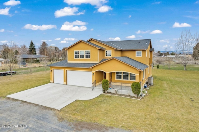 traditional-style house with a garage, concrete driveway, a front lawn, and stucco siding