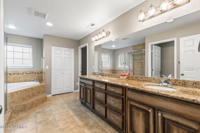 full bathroom featuring a stall shower, visible vents, a sink, and double vanity