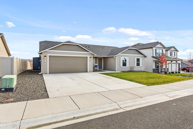 view of front of house featuring a garage, a shingled roof, concrete driveway, fence, and a front lawn