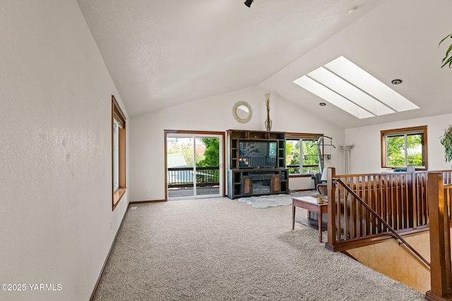 12900 Douglas Rd, Yakima, WA 98908 - carpeted living area featuring a skylight, baseboards, and high vaulted ceiling