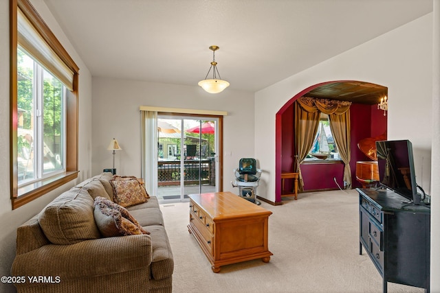 12900 Douglas Rd, Yakima, WA 98908 - living area featuring arched walkways, plenty of natural light, and light colored carpet