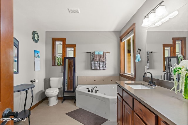 12900 Douglas Rd, Yakima, WA 98908 - bathroom featuring toilet, a whirlpool tub, baseboards, vanity, and tile patterned floors