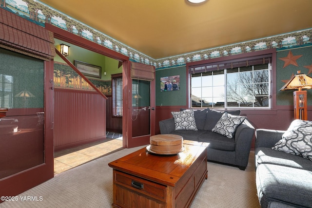 living room with light colored carpet and wallpapered walls