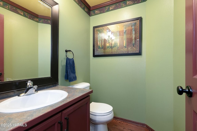 bathroom with vanity, toilet, and wood finished floors