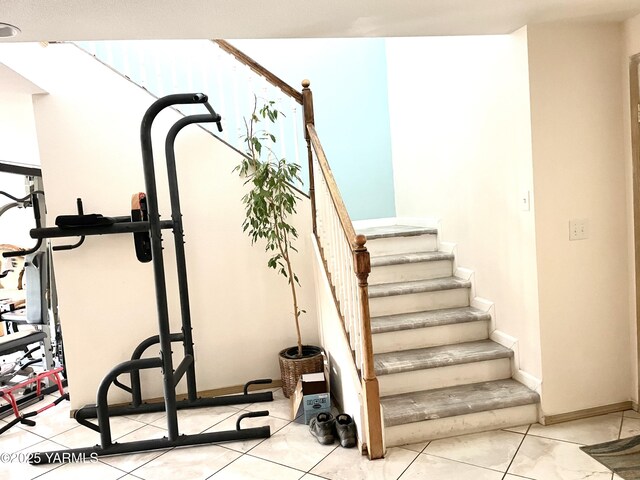 staircase featuring tile patterned flooring