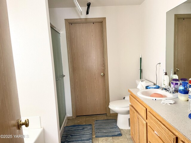 full bathroom with toilet, a stall shower, and vanity