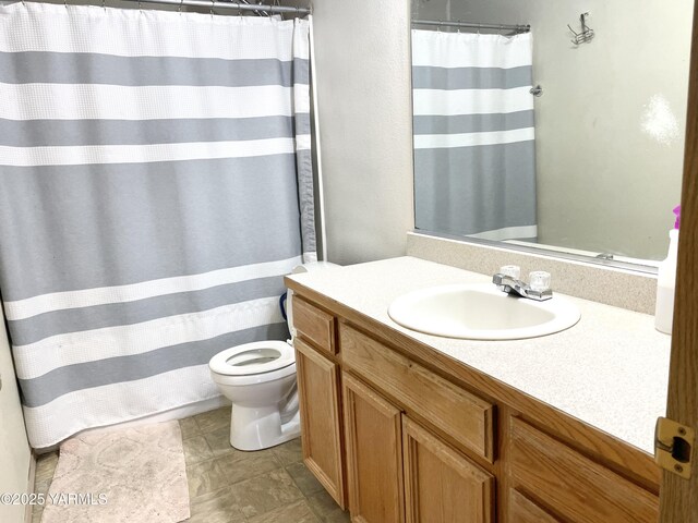 bathroom with toilet, vanity, and a shower with curtain