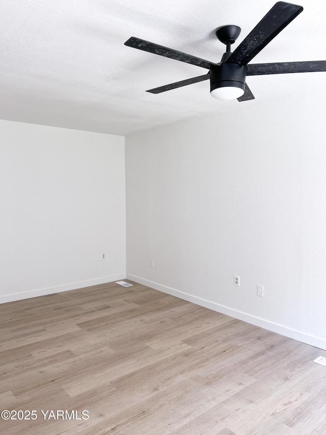 409 Elm Ave, Grandview, WA 98930 - spare room with a ceiling fan, light wood-style flooring, and baseboards