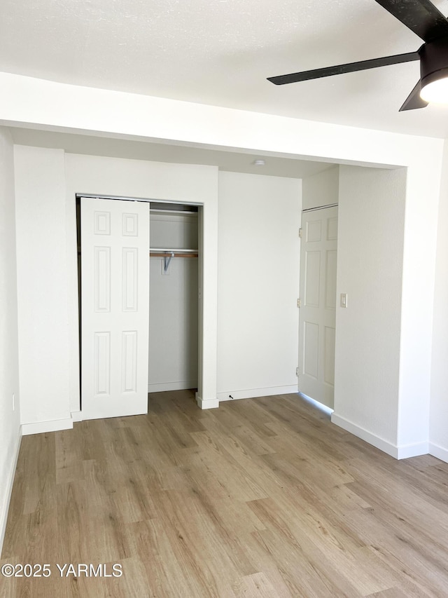409 Elm Ave, Grandview, WA 98930 - unfurnished bedroom featuring light wood finished floors, a closet, baseboards, and a ceiling fan