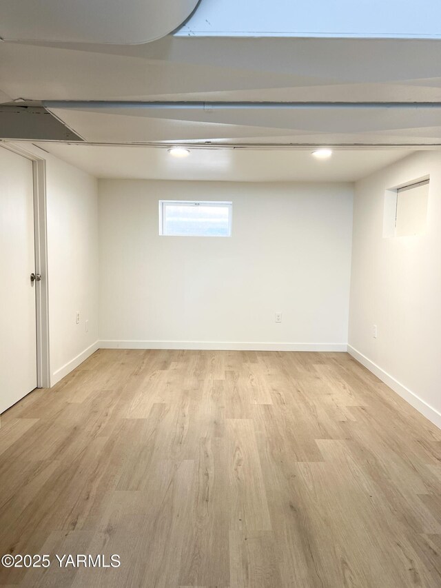 409 Elm Ave, Grandview, WA 98930 - below grade area featuring wood finished floors and baseboards