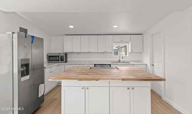 810 S 6th Ave, Yakima, WA 98902 - kitchen featuring stainless steel appliances, butcher block countertops, light wood finished floors, white cabinetry, and recessed lighting