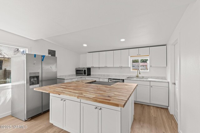 810 S 6th Ave, Yakima, WA 98902 - kitchen with stainless steel appliances, wood counters, white cabinetry, light wood finished floors, and recessed lighting