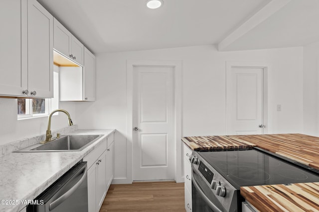 810 S 6th Ave, Yakima, WA 98902 - kitchen featuring wood counters, appliances with stainless steel finishes, white cabinets, light wood-style floors, and recessed lighting