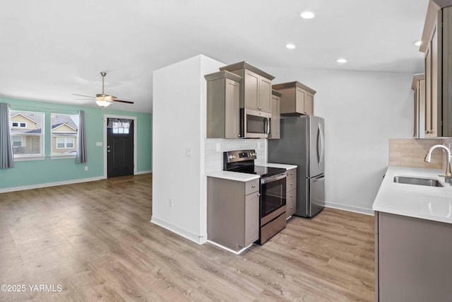 5301 Sage Way, Yakima, WA 98901 - kitchen featuring appliances with stainless steel finishes, decorative backsplash, light wood-style flooring, ceiling fan, and recessed lighting