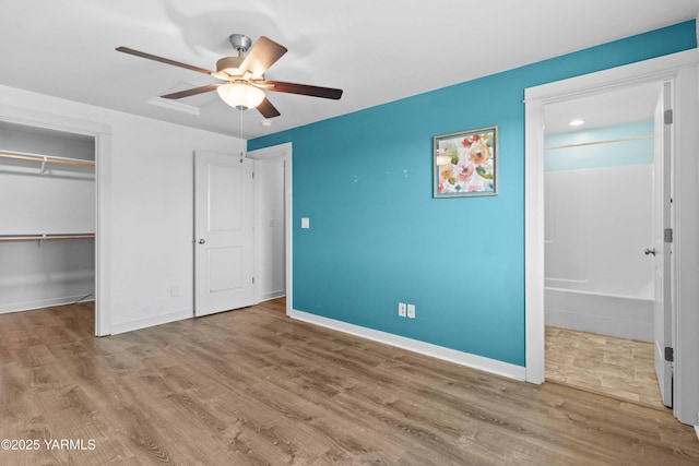 5301 Sage Way, Yakima, WA 98901 - unfurnished bedroom featuring wood finished floors, ensuite bathroom, a closet, and ceiling fan