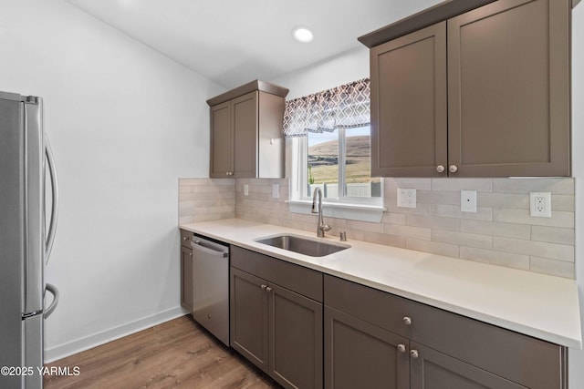 5301 Sage Way, Yakima, WA 98901 - kitchen with stainless steel appliances, light wood-type flooring, tasteful backsplash, light countertops, and recessed lighting